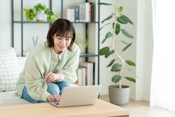 スッキリした居間で仕事する女性