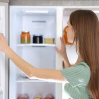 冷蔵庫の中をチェックしている女性